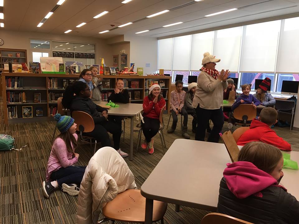 a school librarian engages students with a warm-up activity