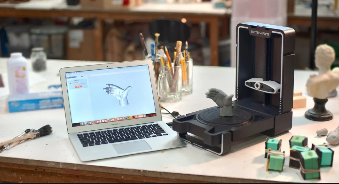the matter and form 3d scanner with a digital design on a laptop
