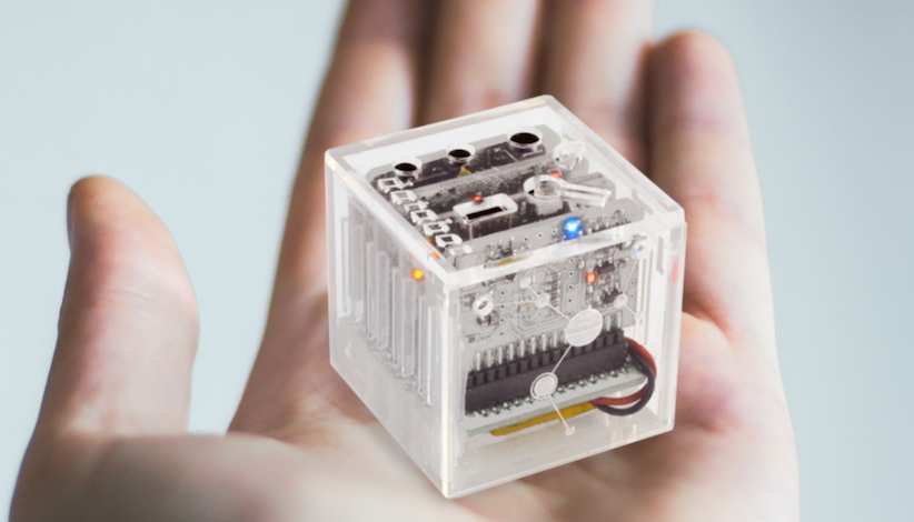 a person holding the databot robot in the palm of their hand