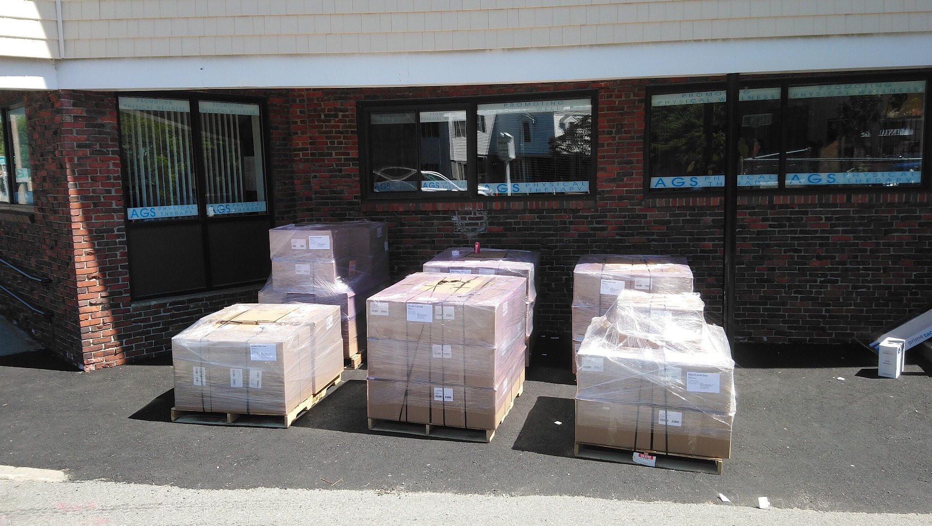 pallets of shipments sitting on the sidewalk for shipping