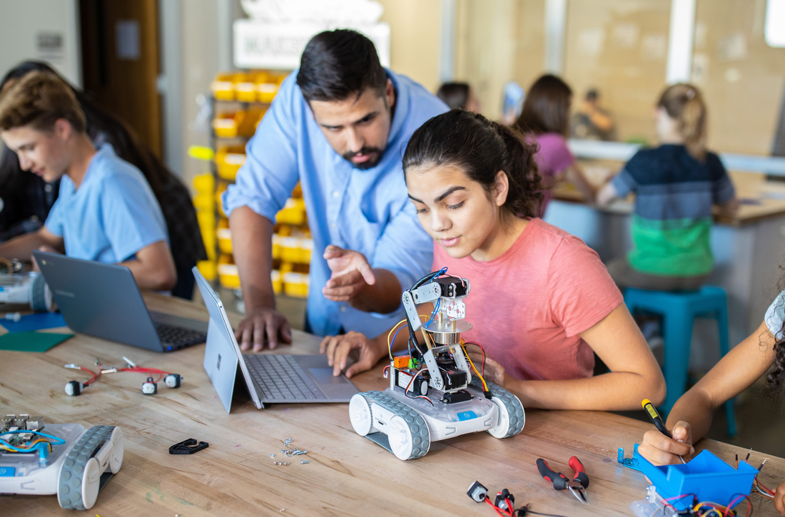 a student and teacher programming the sphero rvr with an external device attached