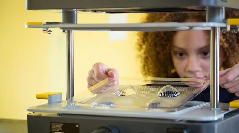 students using the mayku formbox and a sheet to cast 3D molds