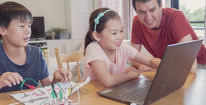 students using a computer for a STEM project at home