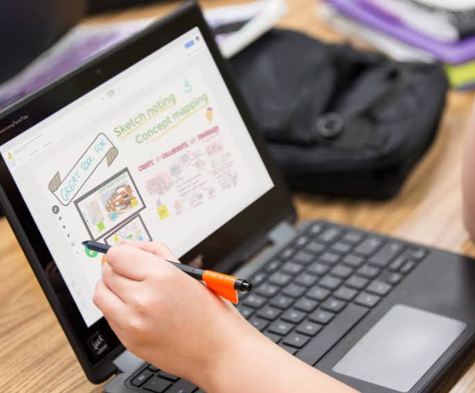 a computer screen displays the google jamboard tool on a chromebook