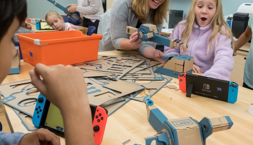 students using cardboard in an art project to learn about STEAM education