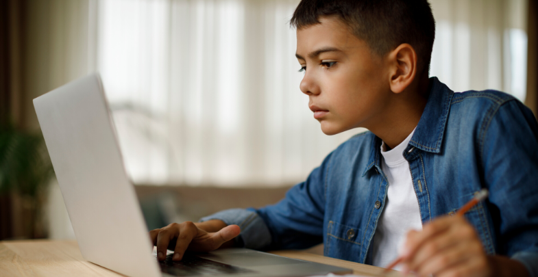 a student using a laptop to learn remotely