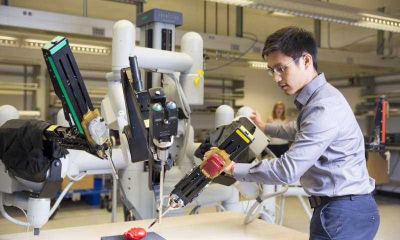 a robotics scientist working on a machine with a drilling tool