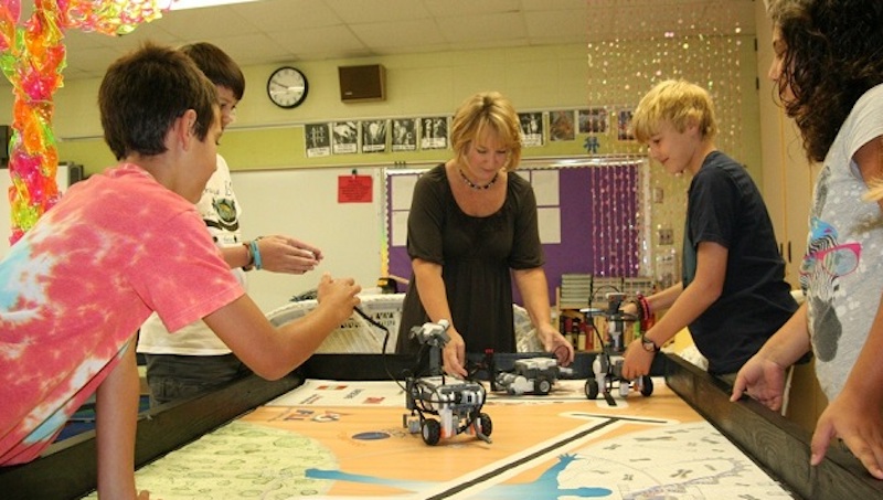 students working with a robot after starting a school makerspace