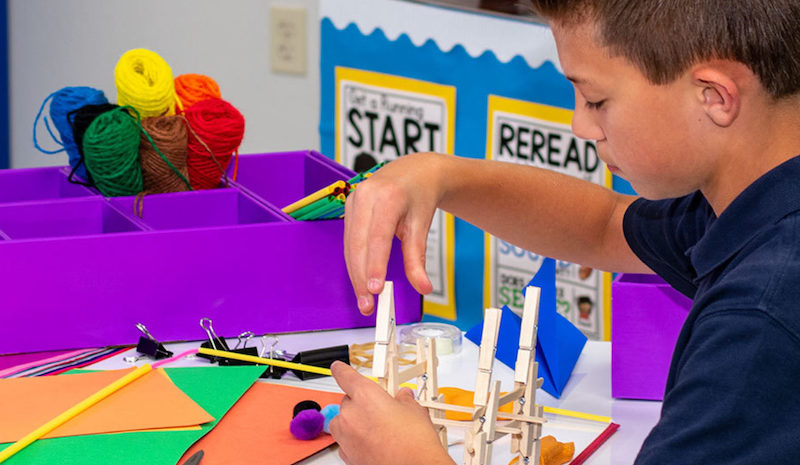 a student building a structure in a STEM lesson plan