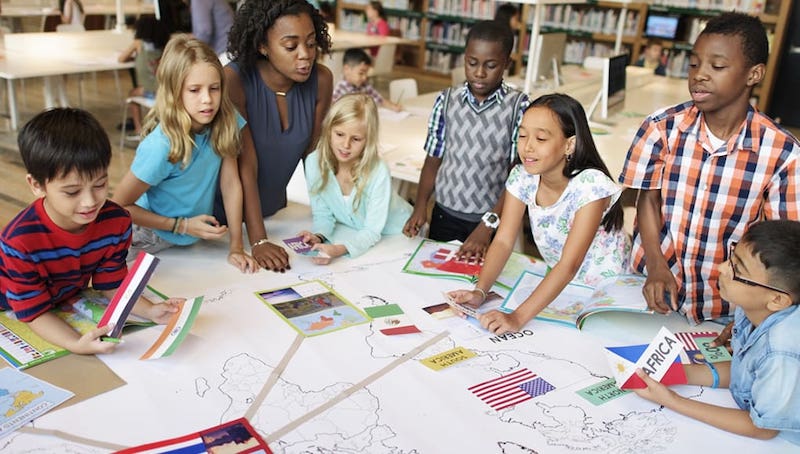 students working as part of a group with a teacher on a PBL unit