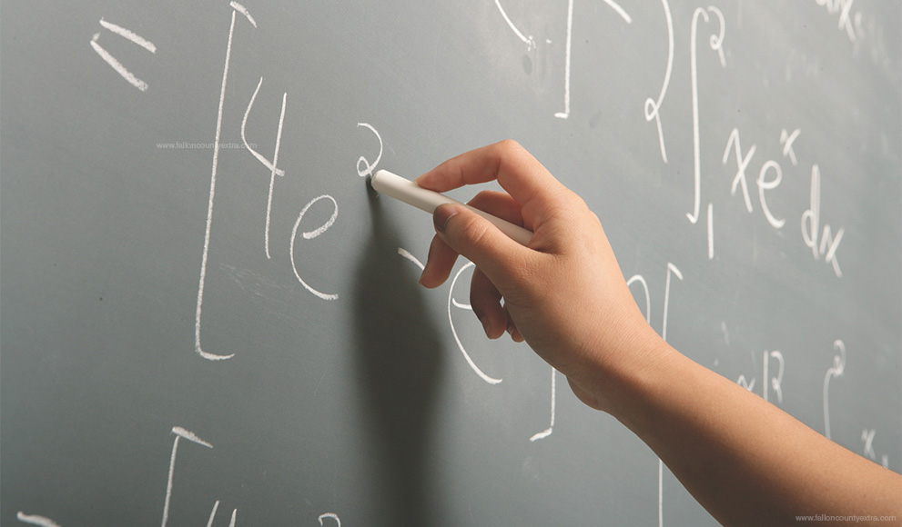 a student solves a math and statistics equation on a chalkboard in a STEM class