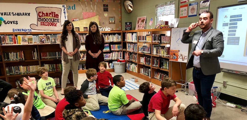 teachers speak to students about STEM in the school library