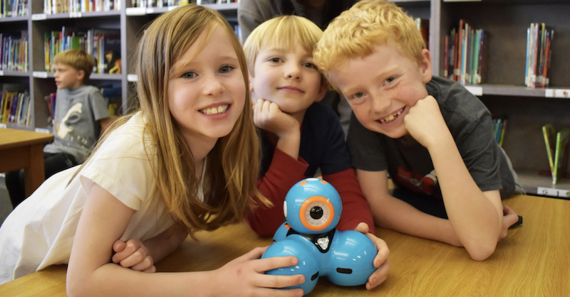students use the dash robot to learn coding in the school library