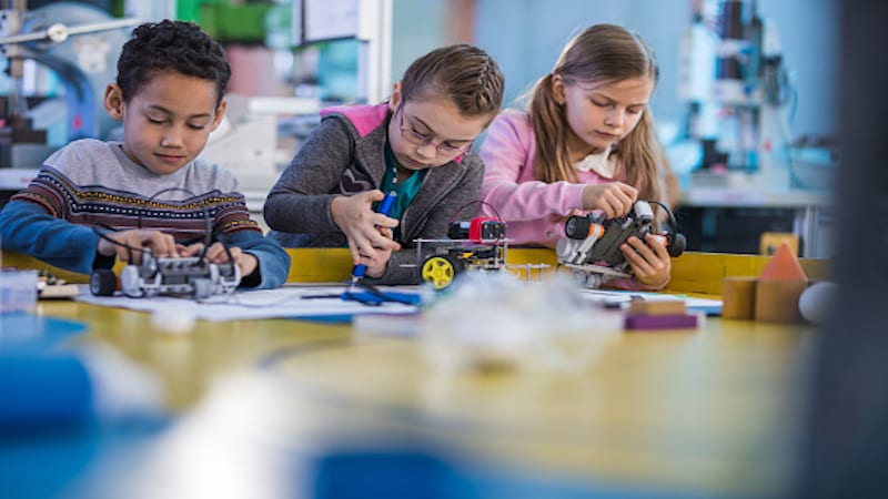 young students working on a robotics project intended for makerspaces