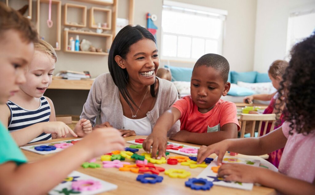 young students in early education using building blocks with a teacher