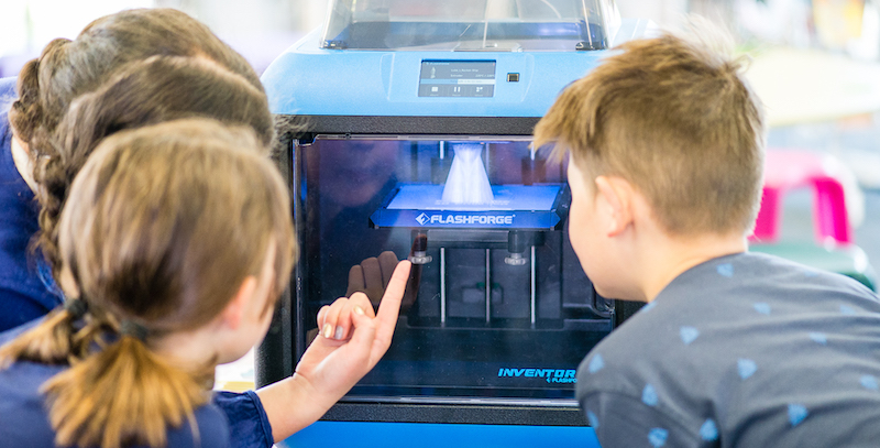 elementary students working on a 3D printing project in a classroom