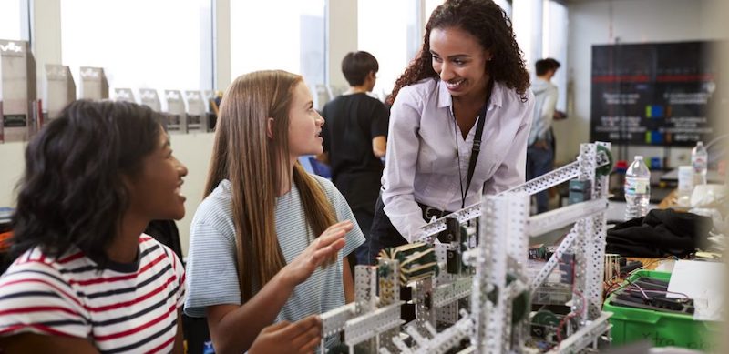 students completing a stem project with a teacher