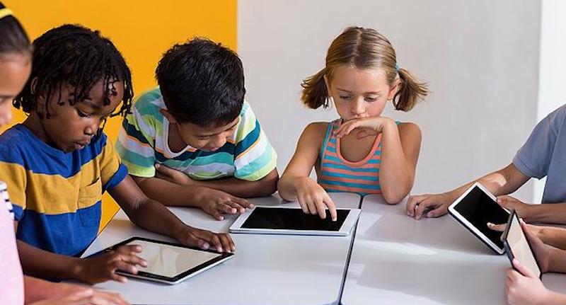 early education students using tablets in the classroom