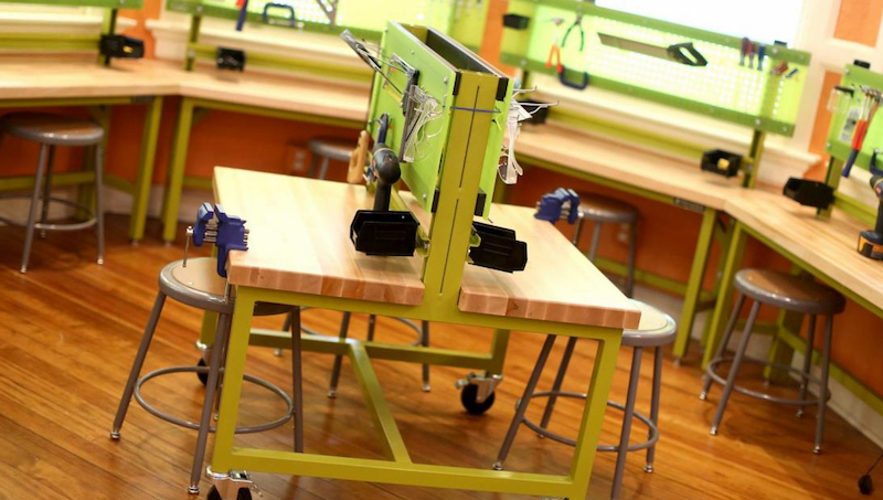 a school makerspace with tables, desks, and stools for STEM learning