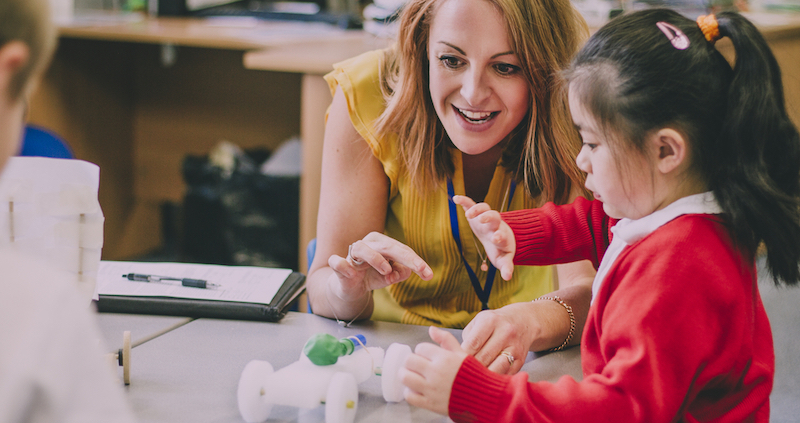 a young student fosters inventiveness while building a robot in the classroom