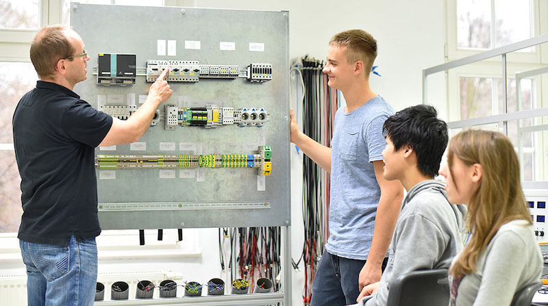 a CTE instructor doing a demonstration for high school students in a classroom