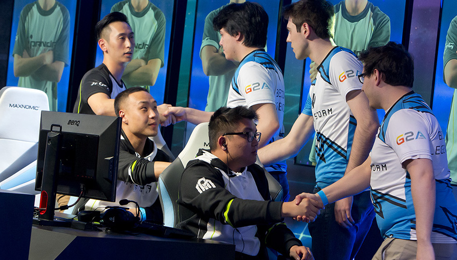 students from two esports teams shake hands after a match