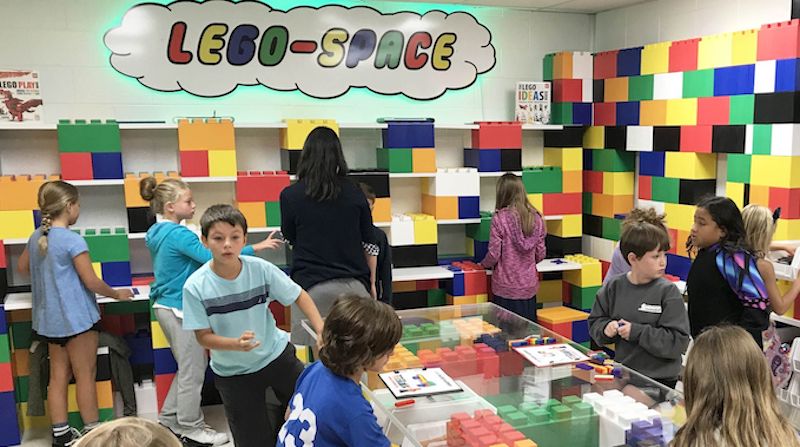 elementary students working together on projects in a school makerspace