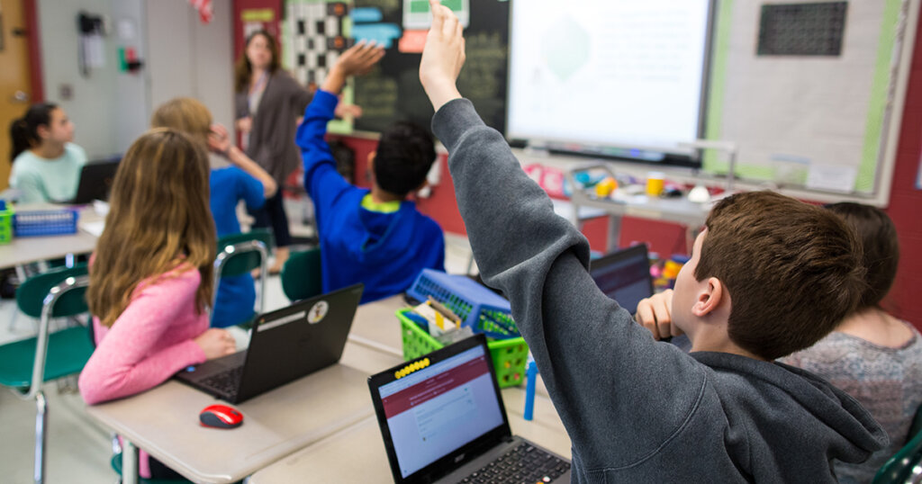 students using chromebooks in an elementary school classroom