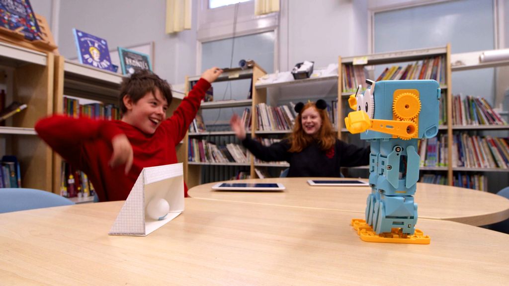 a student learning with the marty v2 robot in a classroom