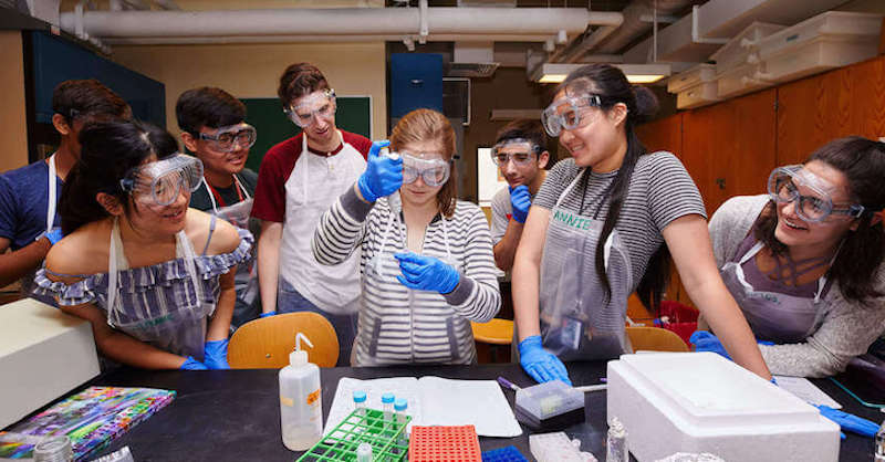 students conducting a science experiment in afterschool STEM learning