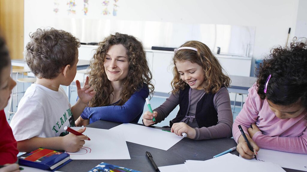 a teacher working with elementary students on scaffolding STEM lessons