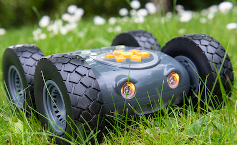 the tuff-bot robot from terrapin sitting in some grass