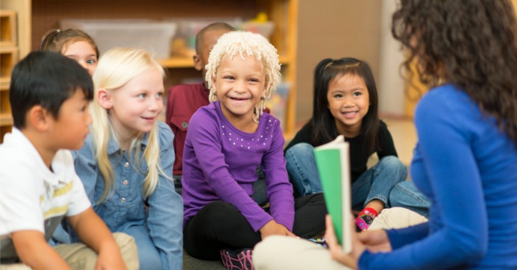 students in a classroom smiling talking about SEL and equity