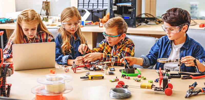 students moving from STEM to STEAM while working on an engineering project in a school makerspace