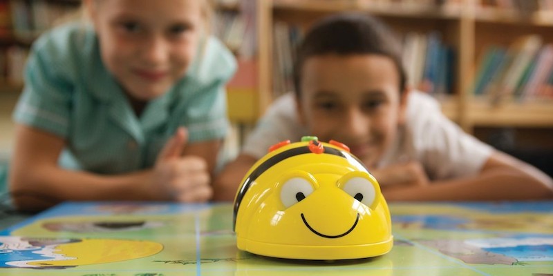 young students using the bee-bot robot in early education after receiving a grant