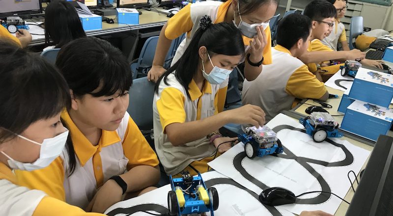 students working with educational robots in a maker education program