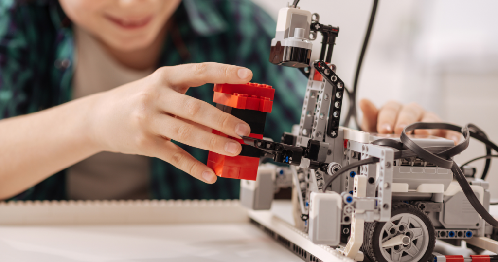 a student building a robotic device in the classroom