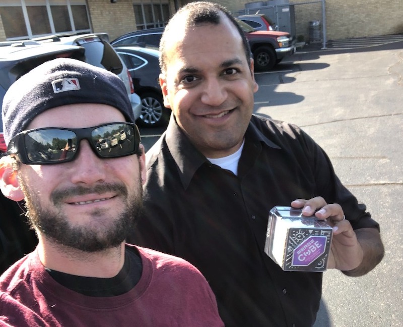 two men pose with a merge cube outside the westchester primary school in chicago