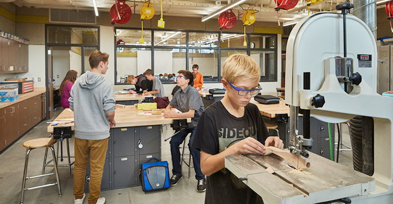 a student using a hghi-tech machine in a makerspace