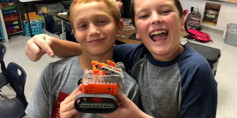 students coding and working together with the Edison robot