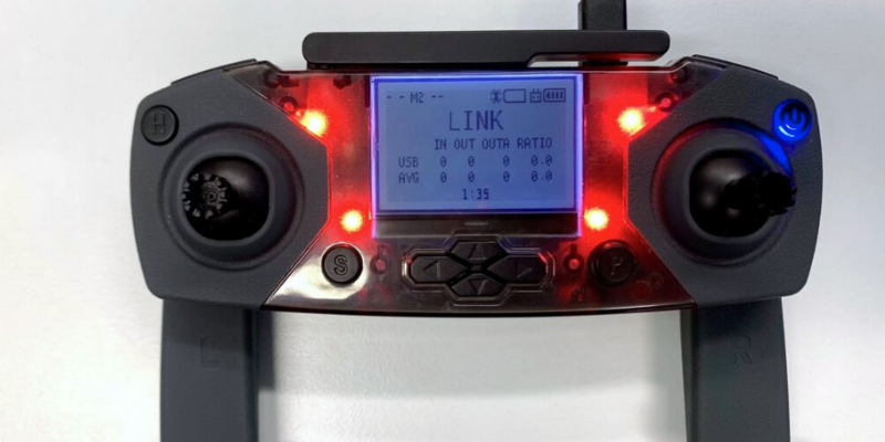 a handheld drone controller displaying readings on the screen