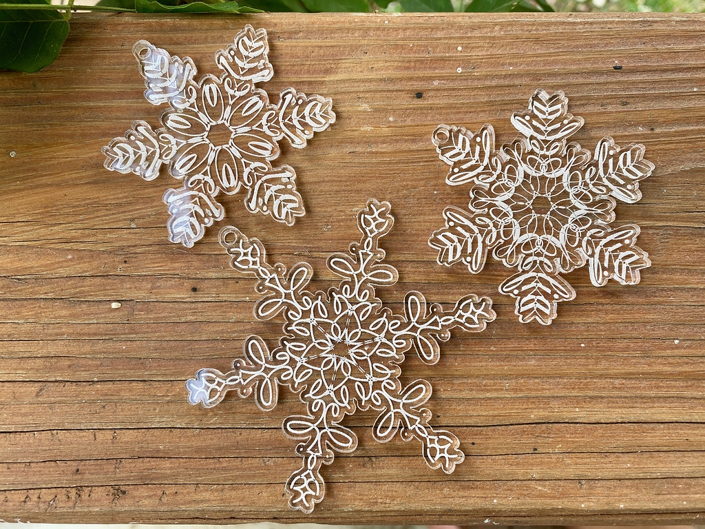Snowflakes engraved into acrylic on a Glowforge 3D laser printer