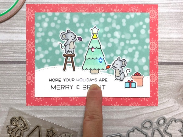 A holiday card with mice putting ornaments on a tree. The card has glowing elements from Chibitronics
