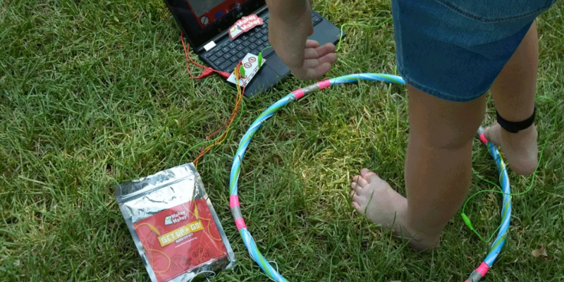 student playing with makey makey get up and go at a summer camp